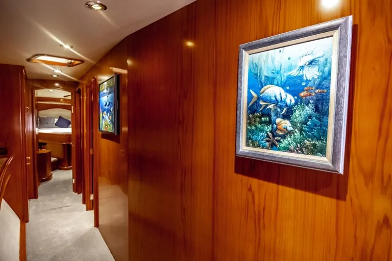 Reel Deal Yacht Photos Pics Luxurious 2005 Sea Force Sportfish yacht interior with wood paneling and marine-themed artwork.