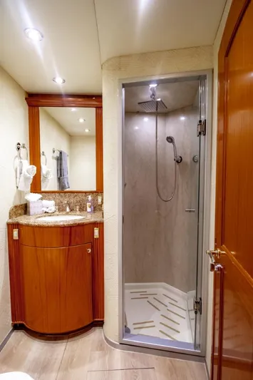 Reel Deal Yacht Photos Pics Luxurious bathroom in 2005 Sea Force Sportfish yacht with shower and wooden cabinetry.