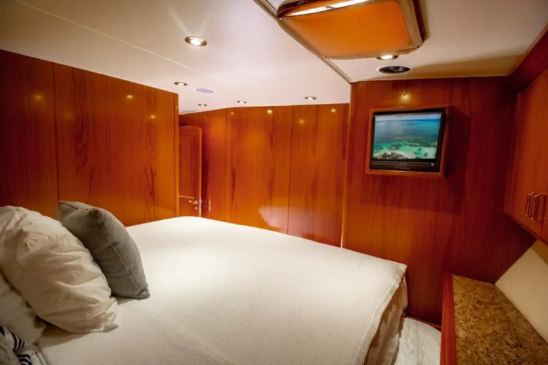 Reel Deal Yacht Photos Pics Luxurious cabin interior of 2005 Sea Force Sportfish yacht with wood paneling and TV.