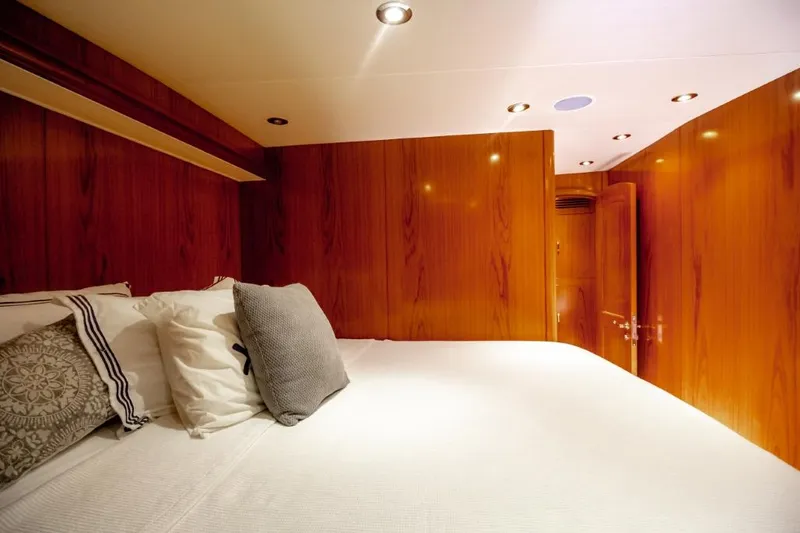 Reel Deal Yacht Photos Pics Luxurious cabin interior of 2005 Sea Force Sportfish yacht with wooden paneling and cozy bedding.