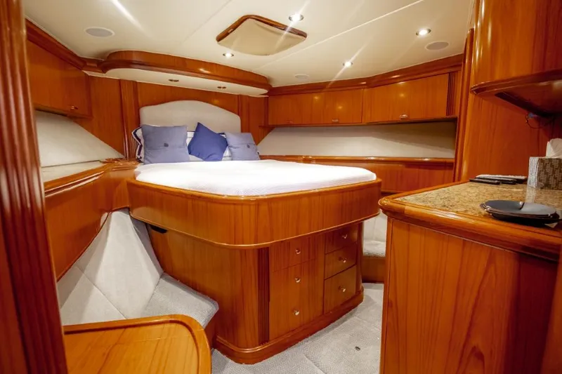 Reel Deal Yacht Photos Pics Luxurious 2005 Sea Force Sportfish cabin with wooden interior and cozy bed.