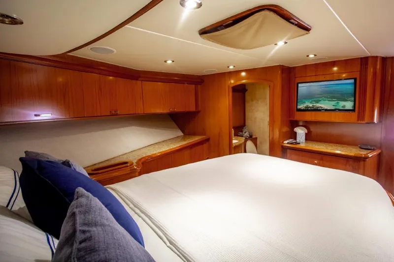 Reel Deal Yacht Photos Pics Luxurious cabin interior of 2005 Sea Force Sportfish yacht with wood paneling and cozy bedding.