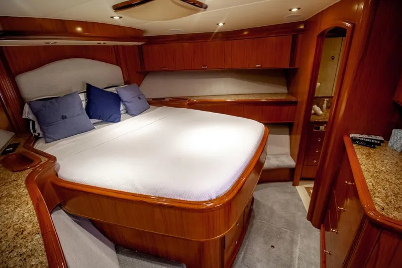 Reel Deal Yacht Photos Pics Luxurious cabin interior of a 2005 Sea Force Sportfish yacht with elegant wood finishes.