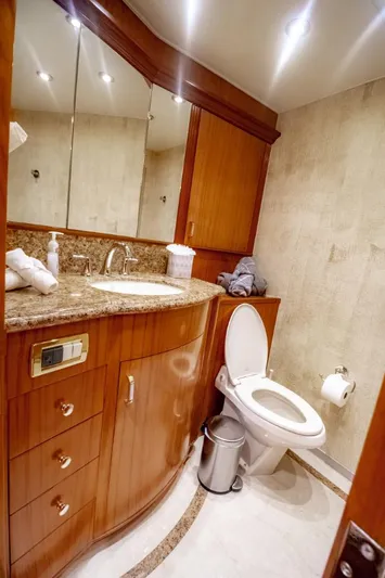 Reel Deal Yacht Photos Pics Luxurious bathroom in 2005 Sea Force Sportfish yacht with wooden cabinetry and granite countertop.