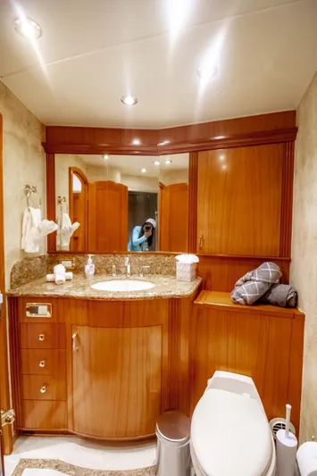 Reel Deal Yacht Photos Pics Luxurious bathroom in 2005 Sea Force Sportfish yacht with wooden cabinetry and modern fixtures.