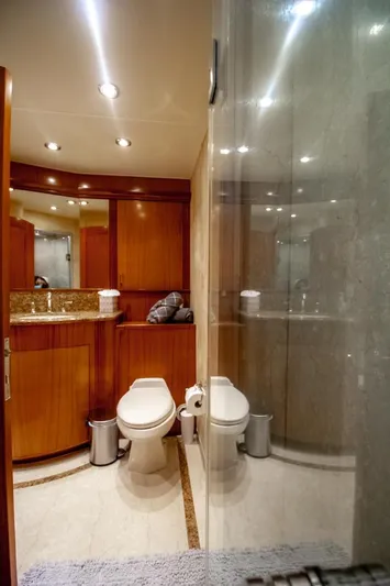 Reel Deal Yacht Photos Pics Luxurious bathroom in 2005 Sea Force Sportfish yacht with modern fixtures and wooden cabinetry.