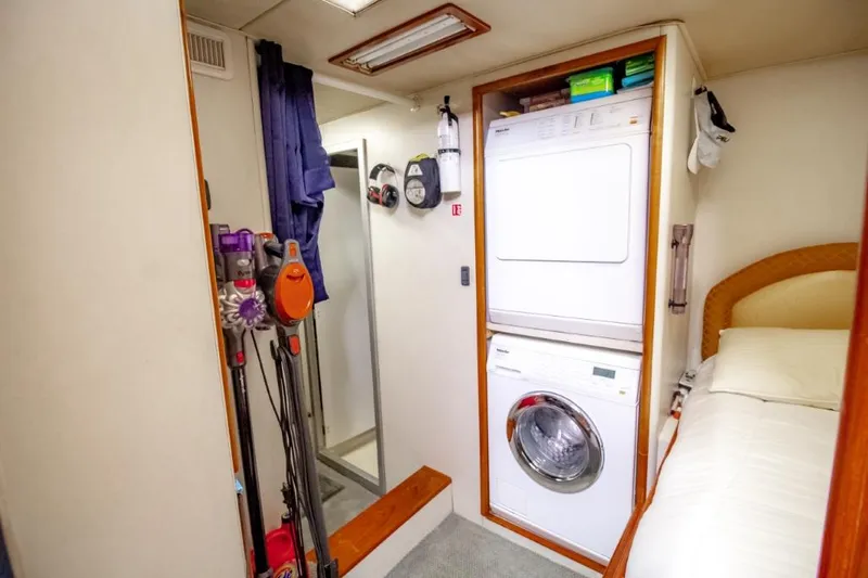 Reel Deal Yacht Photos Pics 2005 Sea Force Sportfish interior with laundry area, vacuum cleaners, and bed.