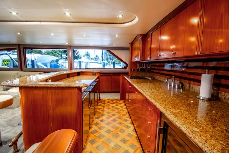 Reel Deal Yacht Photos Pics Luxurious 2005 Sea Force Sportfish yacht interior with elegant wood cabinetry and granite countertops.