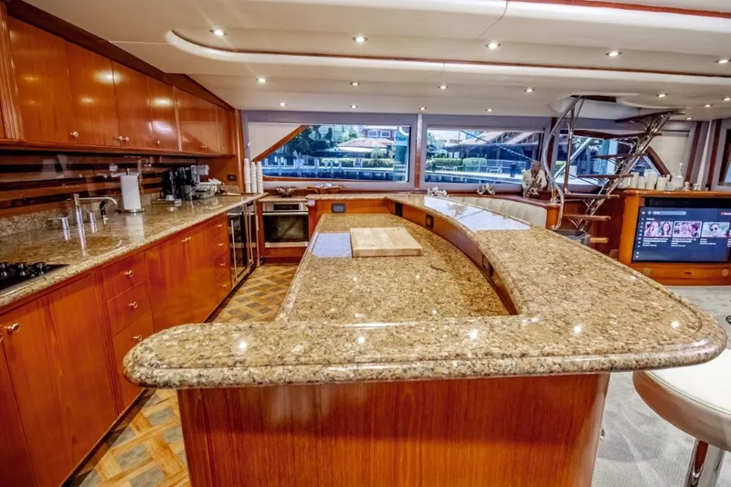 Reel Deal Yacht Photos Pics Luxurious 2005 Sea Force Sportfish yacht interior with granite countertops and wooden cabinetry.