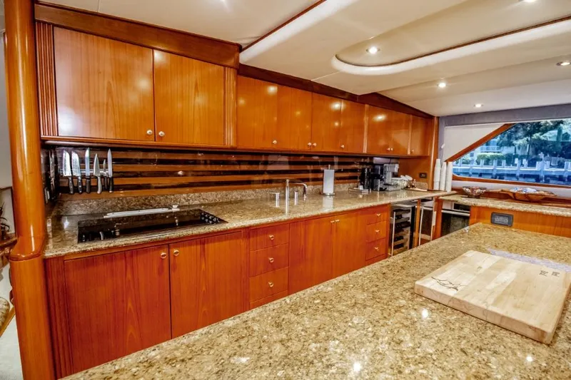 Reel Deal Yacht Photos Pics Luxurious 2005 Sea Force Sportfish yacht kitchen with granite countertops and wooden cabinetry.