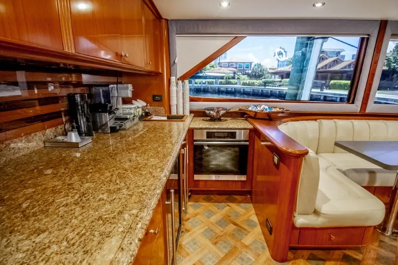 Reel Deal Yacht Photos Pics Luxurious 2005 Sea Force Sportfish yacht interior with modern kitchen and dining area.