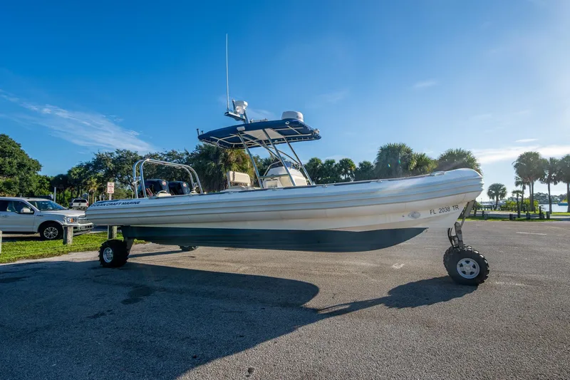 No Name Yacht Photos Pics 2023 Ocean Craft 38 boat with wheels on a sunny day, parked near palm trees.