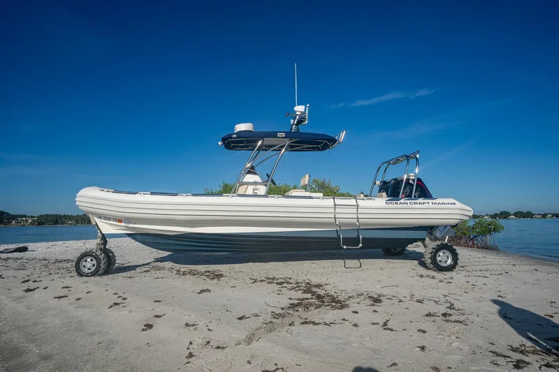 No Name Yacht Photos Pics 2023 Ocean Craft 38 amphibious boat on sandy beach with clear blue sky.