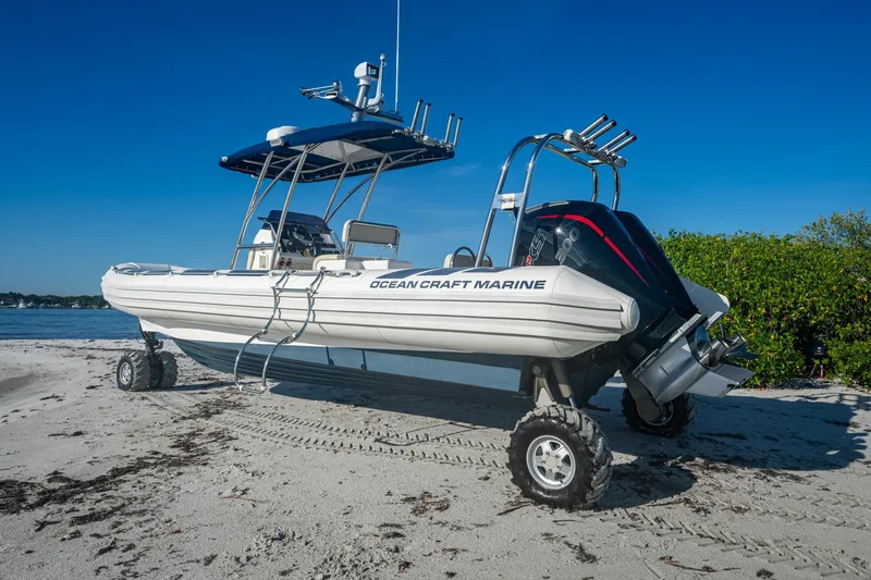 No Name Yacht Photos Pics 2023 Ocean Craft 38 amphibious boat on sandy beach with clear blue sky.