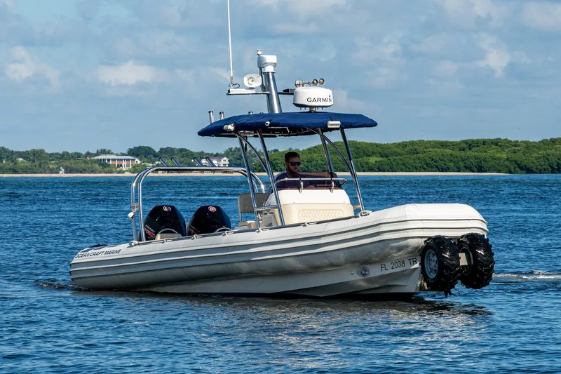 No Name Yacht Photos Pics 2023 Ocean Craft 38 boat cruising on a sunny day with lush greenery in the background.