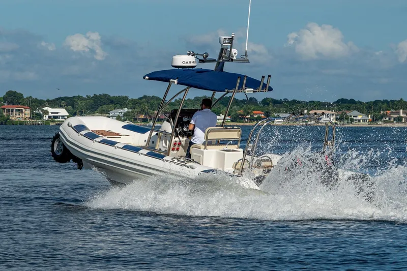 No Name Yacht Photos Pics 2023 Ocean Craft 38 boat cruising on water, creating splashes, with scenic background.
