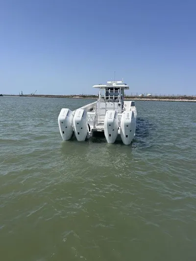  Yacht Photos Pics 2024 Twin Vee 400 GFX boat with multiple engines on open water.