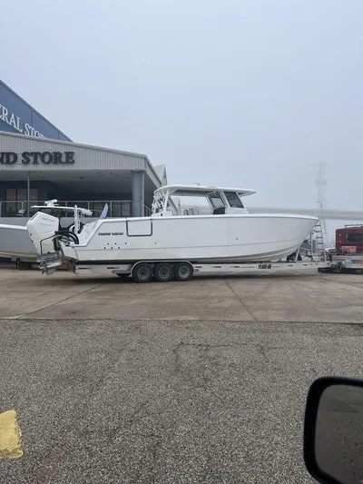  Yacht Photos Pics 2024 Twin Vee 400 GFX boat on trailer at a marina.