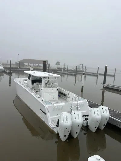  Yacht Photos Pics 2024 Twin Vee 400 GFX boat docked in a foggy marina with triple outboard engines.