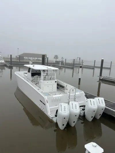  Yacht Photos Pics 2024 Twin Vee 400 GFX boat with triple engines docked on a foggy day.