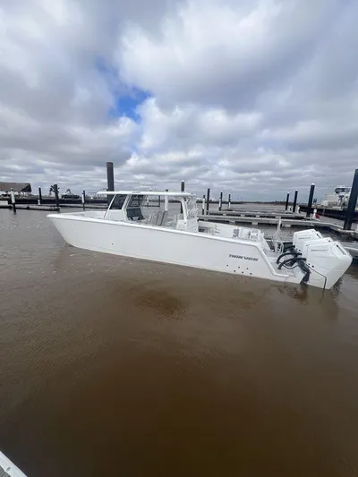  Yacht Photos Pics 2024 Twin Vee 400 GFX boat docked under cloudy skies.