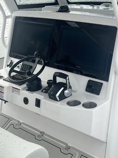  Yacht Photos Pics 2024 Twin Vee 400 GFX boat dashboard with dual screens and controls.