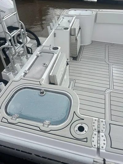  Yacht Photos Pics 2024 Twin Vee 400 GFX boat deck with storage compartments and sleek design.