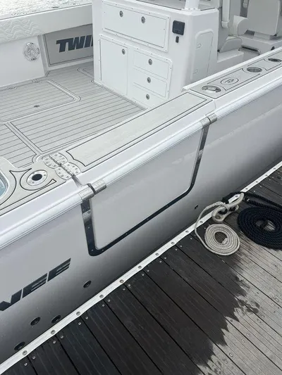  Yacht Photos Pics 2024 Twin Vee 400 GFX boat docked, showcasing sleek design and deck features.