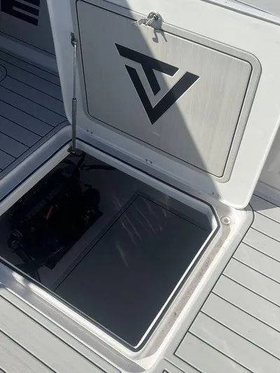  Yacht Photos Pics 2024 Twin Vee 400 GFX boat storage compartment with logo on hatch.