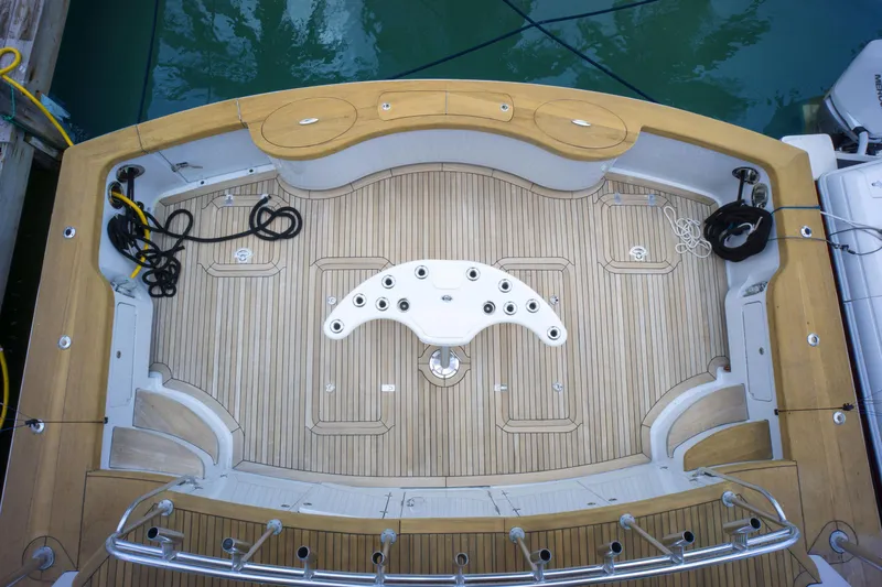 Reel Deal Yacht Photos Pics 2005 Sea Force IX Sportfish boat deck with teak flooring and fishing rod holders.