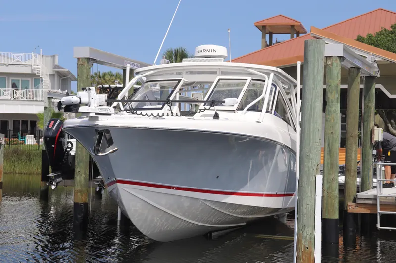 Reel Grateful Yacht Photos Pics 2021 Albemarle 31 DC boat docked with Garmin equipment, surrounded by waterfront homes.