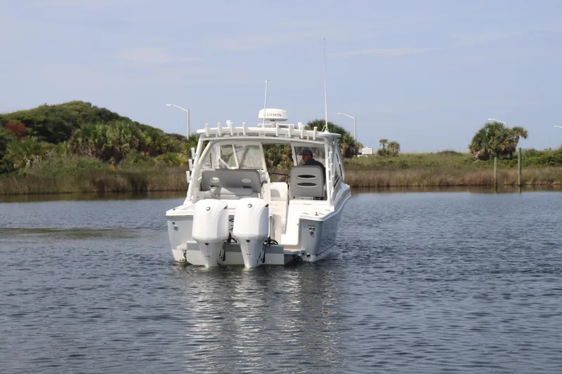 Reel Grateful Yacht Photos Pics 2021 Albemarle 31 DC boat cruising on a calm waterway with lush greenery.