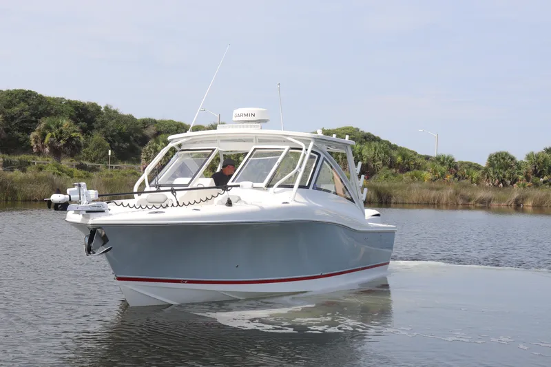 Reel Grateful Yacht Photos Pics 2021 Albemarle 31 DC boat cruising on a calm waterway with lush greenery.