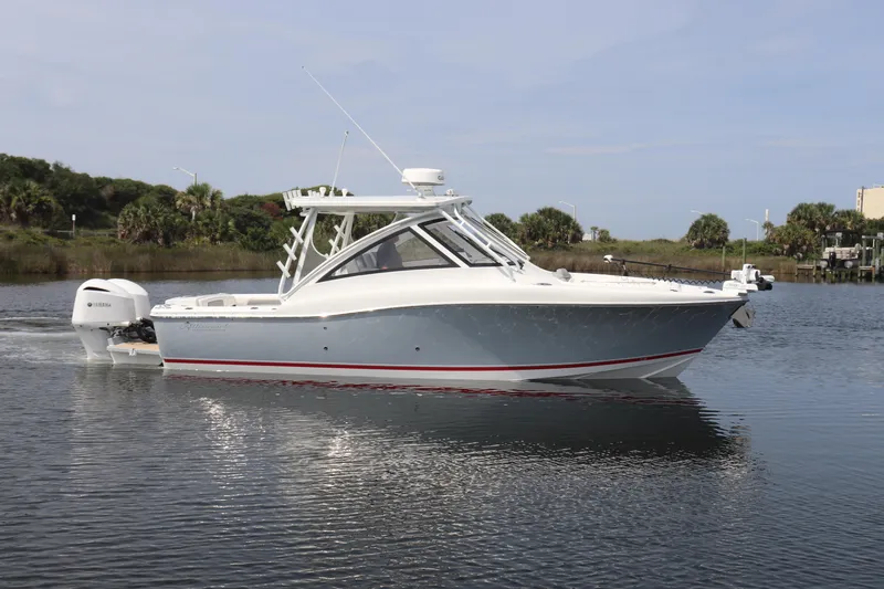 Reel Grateful Yacht Photos Pics 2021 Albemarle 31 DC boat on calm water, featuring sleek design and modern outboard motor.
