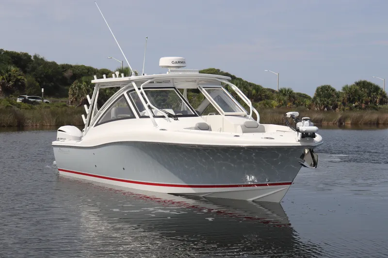 Reel Grateful Yacht Photos Pics 2021 Albemarle 31 DC boat on calm water with lush greenery background.