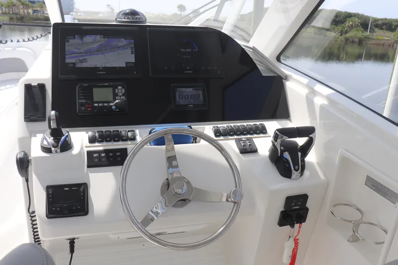 Reel Grateful Yacht Photos Pics 2021 Albemarle 31 DC boat dashboard with steering wheel, navigation screens, and controls.
