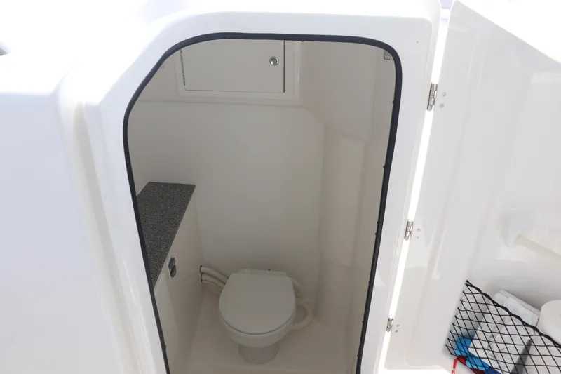 Reel Grateful Yacht Photos Pics 2021 Albemarle 31 DC boat interior with compact marine toilet and storage.
