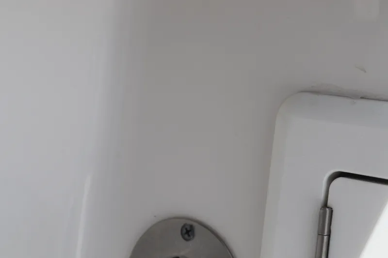 Reel Grateful Yacht Photos Pics Close-up of 2021 Albemarle 31 DC boat interior detail, featuring a metal fixture and hinge.