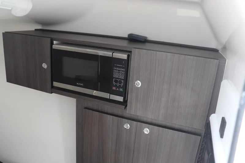 Reel Grateful Yacht Photos Pics 2021 Albemarle 31 DC interior with modern microwave and sleek cabinetry.