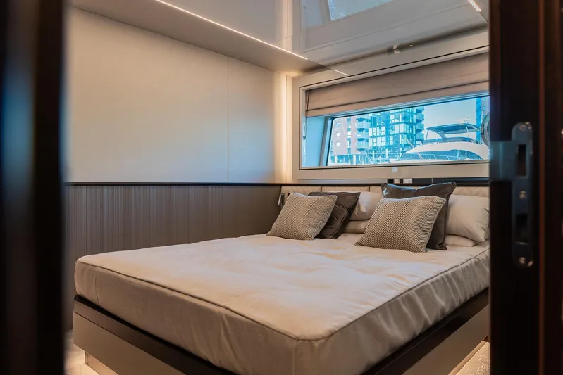  Yacht Photos Pics Luxurious bedroom interior on 2025 Sunseeker 90 Ocean yacht, featuring modern design and large window.