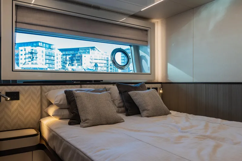  Yacht Photos Pics Luxurious bedroom interior of 2025 Sunseeker 90 Ocean yacht with cityscape view.