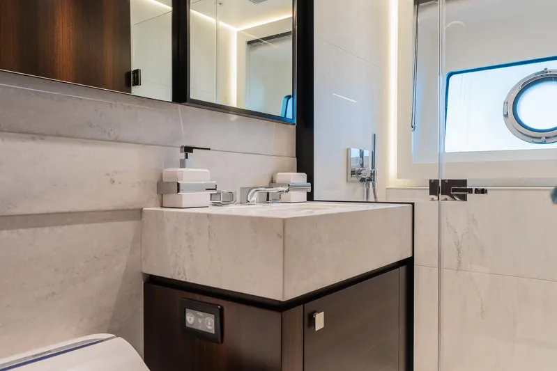  Yacht Photos Pics Luxurious bathroom in 2025 Sunseeker 90 Ocean yacht with modern fixtures and porthole window.