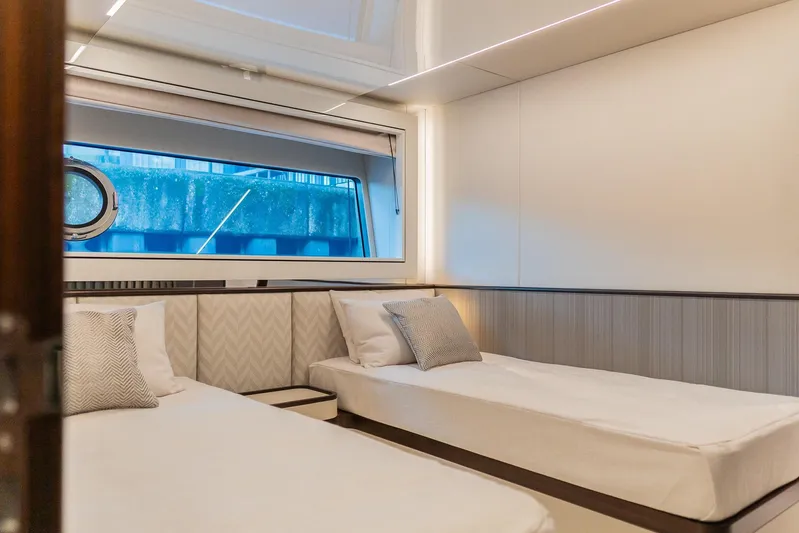  Yacht Photos Pics Luxurious cabin interior of 2025 Sunseeker 90 Ocean yacht with twin beds.