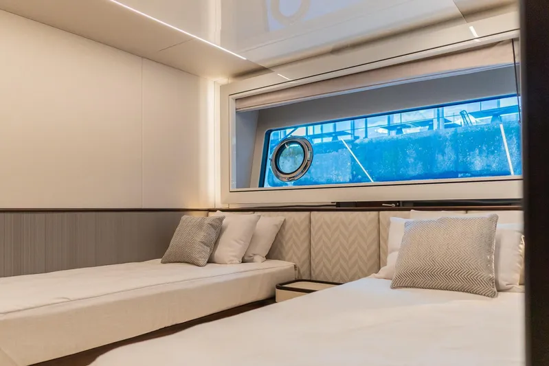  Yacht Photos Pics Luxurious cabin interior of 2025 Sunseeker 90 Ocean yacht with twin beds and modern decor.