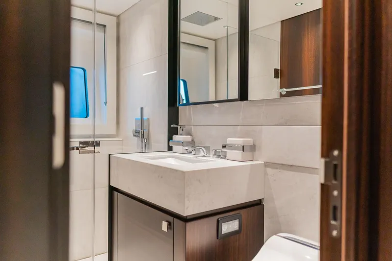  Yacht Photos Pics Luxurious bathroom interior of 2025 Sunseeker 90 Ocean yacht, featuring modern fixtures and elegant design.