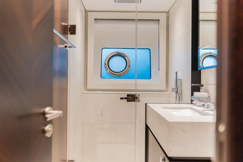  Yacht Photos Pics Luxurious bathroom on 2025 Sunseeker 90 Ocean yacht with porthole window.