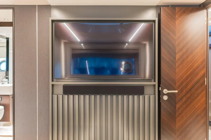  Yacht Photos Pics Luxurious interior of 2025 Sunseeker 90 Ocean yacht with modern TV setup.