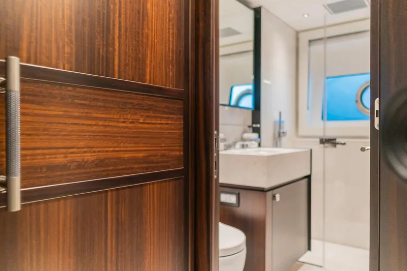  Yacht Photos Pics Luxurious bathroom interior on 2025 Sunseeker 90 Ocean yacht, featuring elegant wood finishes.