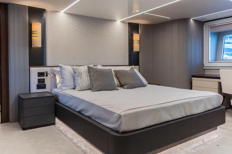  Yacht Photos Pics Luxurious bedroom interior of 2025 Sunseeker 90 Ocean yacht, featuring modern design and elegant furnishings.