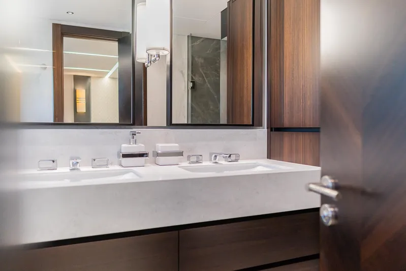  Yacht Photos Pics Luxurious bathroom interior on 2025 Sunseeker 90 Ocean yacht, featuring modern fixtures and wood accents.